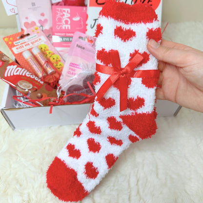 Red and white fluffy socks with love hearts tied together with red ribbon which are included in the Love You Gift Box
